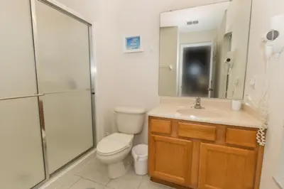 a bathroom with a toilet and a shower and a sink at Peaceful Quiet Pool Home 5 min from Disney! townhouse in Orlando