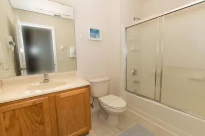 a bathroom with a toilet and a sink and a shower at Peaceful Quiet Pool Home 5 min from Disney! townhouse in Orlando