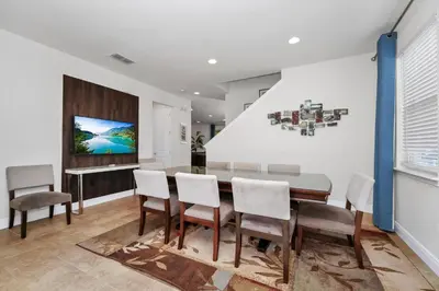 a dining room with a table and chairs at Luxury Home With Private Pool And Water Park & Resort Access Near Disney At Encore Resorts Reunion - 240Mn in Kissimmee