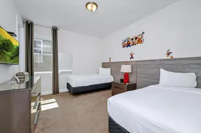 a hotel room with a bed and a desk at Luxury Home With Private Pool And Water Park & Resort Access Near Disney At Encore Resorts Reunion - 240Mn in Kissimmee