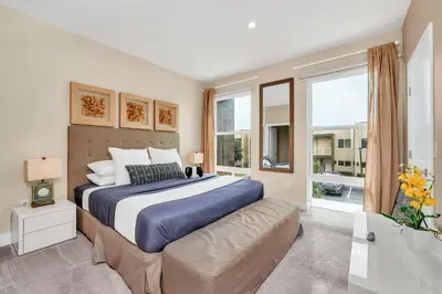 a bedroom with a large bed and a large window at Luxury Villa Less Than A Mile From Disneyworld -Bonus Elevator- in Orlando