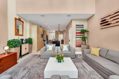 a living room with a couch and a table at Luxury Villa Less Than A Mile From Disneyworld -Bonus Elevator- in Orlando