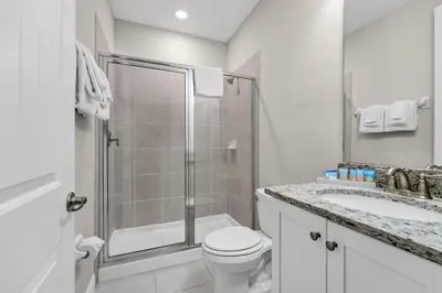 a bathroom with a shower and a toilet and a sink at Alluring Home With Private Pool And Waterpark & Resort Access Near Disney At Encore Resorts Reunion - 280Sf in Kissimmee