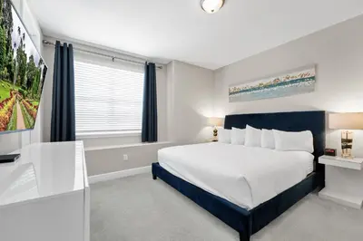 a bedroom with a large bed and a window at Alluring Home With Private Pool And Waterpark & Resort Access Near Disney At Encore Resorts Reunion - 280Sf in Kissimmee