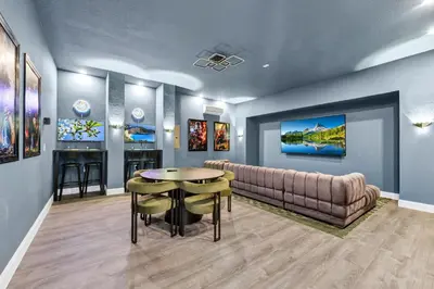a living room with a couch and a table at Alluring Home With Private Pool And Waterpark & Resort Access Near Disney At Encore Resorts Reunion - 280Sf in Kissimmee