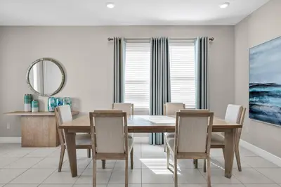 a dining room with a table and chairs and a mirror at Alluring Home With Private Pool And Waterpark & Resort Access Near Disney At Encore Resorts Reunion - 280Sf in Kissimmee