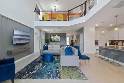 a living room with a couch and a table at Beautiful Family Villa - Pool and Hot Tub - Near Disney World in Kissimmee