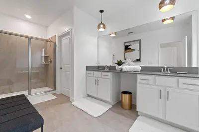 a white bathroom with a sink and a shower at Beautiful Family Villa - Pool and Hot Tub - Near Disney World in Kissimmee