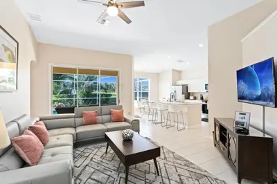 a living room with a couch and a table at South Facing Pool 4 Bedroom 3 Bath Villa villa in Kissimmee