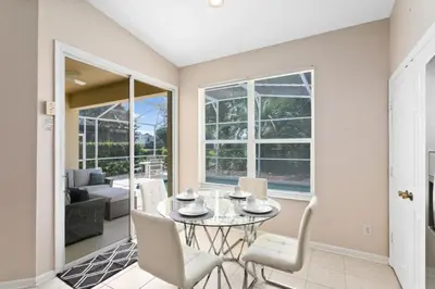a dining room with a table and chairs at South Facing Pool 4 Bedroom 3 Bath Villa villa in Kissimmee