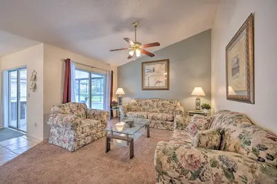 a living room with two couches and a ceiling fan at about 5 Mi to Theme Parks Kissimmee Home with Pool in Orlando