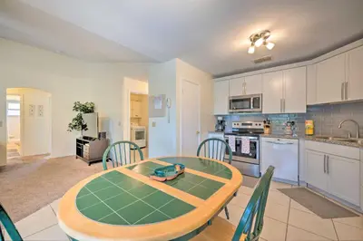 a kitchen and dining room with a table and chairs at about 5 Mi to Theme Parks Kissimmee Home with Pool in Orlando