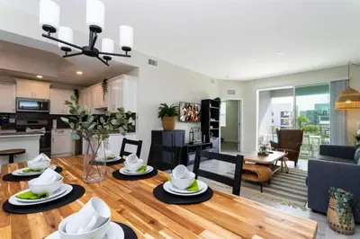 a living room and kitchen with a table and chairs at Gorgeous 3Bd 2Ba Apt Close to Disney @ Storey Lake Orlando 208 3180 in Kissimmee
