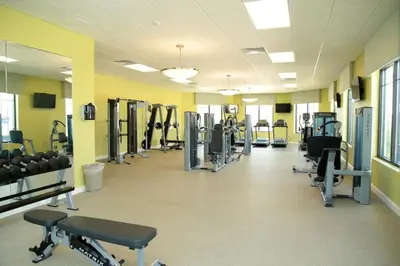 a gym with rows of treadmills and machines at Gorgeous 3Bd 2Ba Apt Close to Disney @ Storey Lake Orlando 208 3180 in Kissimmee