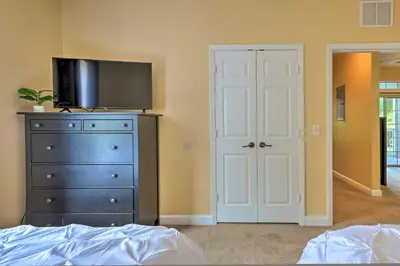 a bedroom with a bed and a dresser with a television on it at Sun-Soaked Kissimmee Gem with Resort Amenities! in Kissimmee