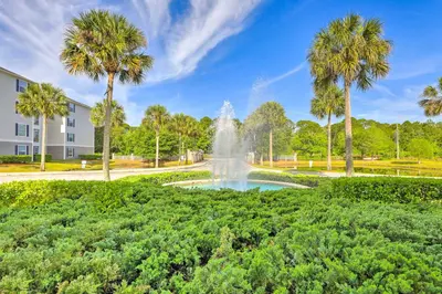 a fountain in a park with palm trees at Sun-Soaked Kissimmee Gem with Resort Amenities! in Kissimmee