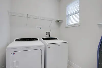 a white kitchen with a stove and a window at Stylish Family Home Private Pool/Spa 10min Disneyworld Sleeps 22 in Orlando