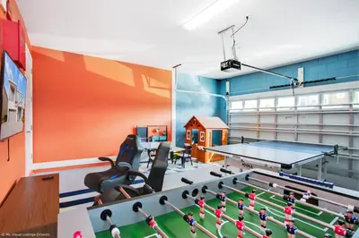 a ping pong room with a ping pong table at Stylish Family Home Private Pool/Spa 10min Disneyworld Sleeps 22 in Orlando