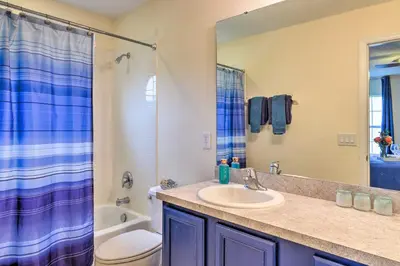 a bathroom with a sink and a toilet and a shower at Less Than 5 Mi to Disney World Resort Home for Families! in Kissimmee