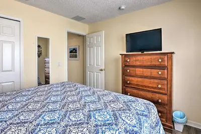 a bedroom with a bed and a tv on a dresser at Less Than 5 Mi to Disney World Resort Home for Families! in Kissimmee