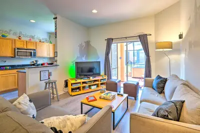 a living room with a couch and a table at Disney-Inspired Townhome with Private Hot Tub! in Orlando