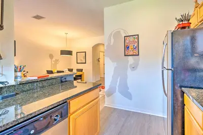 a kitchen with a refrigerator and a counter top at Disney-Inspired Townhome with Private Hot Tub! in Orlando