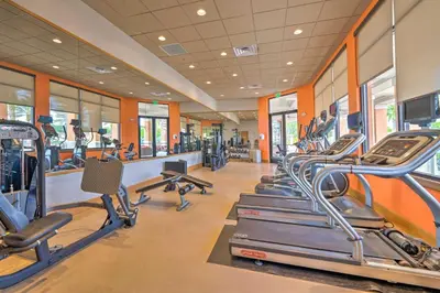 a gym with treadmills and elliptical machines at Disney-Inspired Townhome with Private Hot Tub! in Orlando