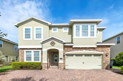 a large house with a brick driveway at Utopic Home With Themed Rooms, Game And Media Room And Waterpark & Resort Access Near Disney At Encore Resorts Reunion - 270Cl in Kissimmee