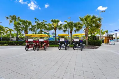a group of four bikes parked in a parking lot at Utopic Home With Themed Rooms, Game And Media Room And Waterpark & Resort Access Near Disney At Encore Resorts Reunion - 270Cl in Kissimmee