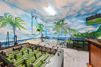 a room with a mural of a soccer game on the wall at Fresh Amazing Family Home. Private Pool. Game Room. Sleeps 24 in Kissimmee