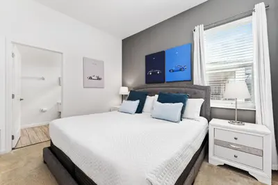 a bedroom with a large bed and a window at Fresh Amazing Family Home. Private Pool. Game Room. Sleeps 24 in Kissimmee