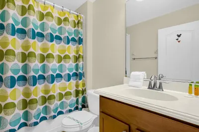 a bathroom with a sink and a shower curtain at Fun Family Villa Pool BBQ Near Disney World 5BR in Kissimmee