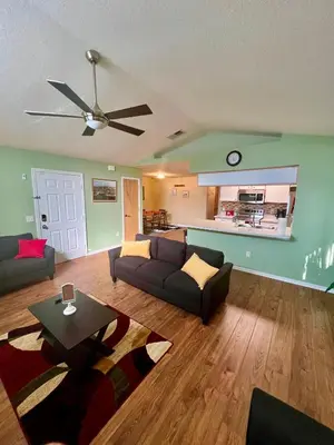 a living room with a couch and a table at Grand Villas of Island 3BR Condo near Disney Parks and Universal in Kissimmee