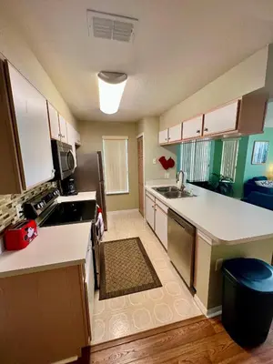 a kitchen with a sink and a counter top at Grand Villas of Island 3BR Condo near Disney Parks and Universal in Kissimmee