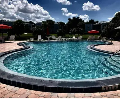 a swimming pool at a resort with blue water at 3648 Orlando Vacational Apartment in Orlando