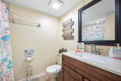 a bathroom with a sink and a toilet and a mirror at 3648 Orlando Vacational Apartment in Orlando