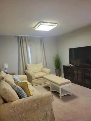 a living room with a couch and a flat screen tv at Paradise Villa Disney Staycation Pool, Fun & Resort Access in Kissimmee