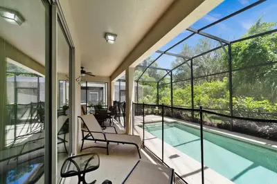 an empty house with a swimming pool and windows at Paradise Villa Disney Staycation Pool, Fun & Resort Access in Kissimmee