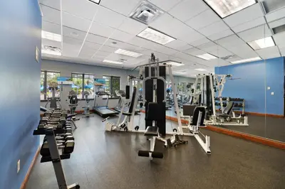 a gym with several treadmills and cardio equipment at Paradise Villa Disney Staycation Pool, Fun & Resort Access in Kissimmee