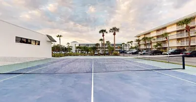 a tennis court with a net in a parking lot at Park Royal Orlando in Kissimmee