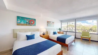 a hotel room with two beds and a window at Park Royal Orlando in Kissimmee