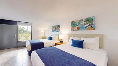 a hotel room with two beds and a window at Park Royal Orlando in Kissimmee