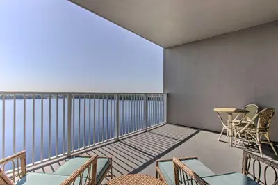 a room with chairs and a table on a balcony at Luxury Condo with Huge Private Balcony on Lake Bryan in Orlando