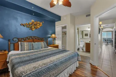 a bedroom with a bed and a blue wall at Luxury Condo with Huge Private Balcony on Lake Bryan in Orlando
