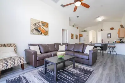 a living room with a couch and a table at 133 Beautiful home with lake view in Kissimmee