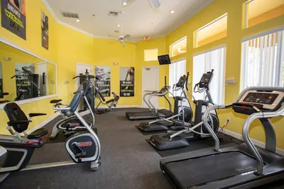 a gym with several exercise bikes in a room at 133 Beautiful home with lake view in Kissimmee