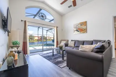 a living room with a couch and a large window at 133 Beautiful home with lake view in Kissimmee