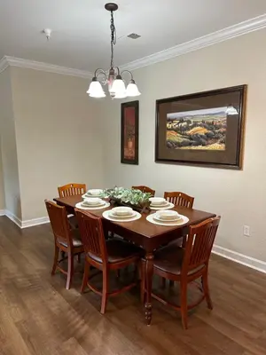 a dining room with a wooden table and chairs at Gone 2 Florida Vacation Homes in Orlando