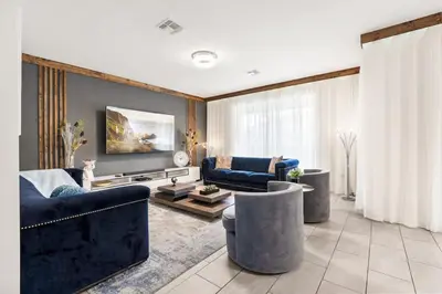 a living room with two blue couches and a tv at Sophisticated 6BR at Storey Lake SL2766 in Kissimmee
