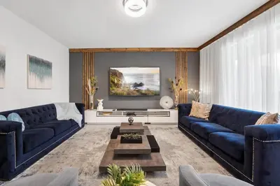 a living room with blue couches and a table at Sophisticated 6BR at Storey Lake SL2766 in Kissimmee